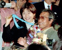 Olympic women's marathon winner Takahashi returns home